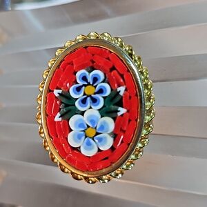 Vintage millefiori micro mosaic flowers pin brooch set in a gold edged frame.
